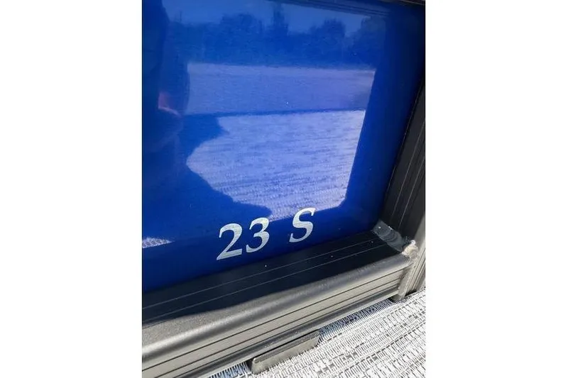 Slide: The Image of Close-up of 2026 Bennington 23 SSB Swing Back Pontoon, blue exterior with '23 S' marking. - 4