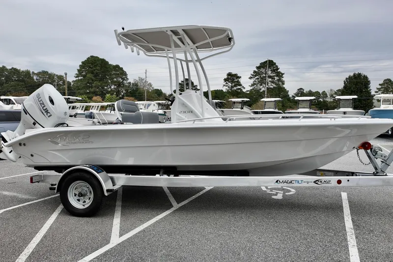 Slide: The Image of 2026 ALK2 23 CRX boat on trailer, featuring Suzuki outboard motor. - 5