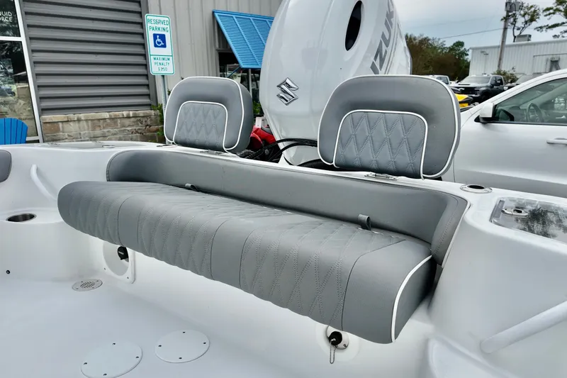 Slide: The Image of ```markdown Gray seating on ALK2 23 CRX boat, 2026 model, with Suzuki engine in background. ``` - 6