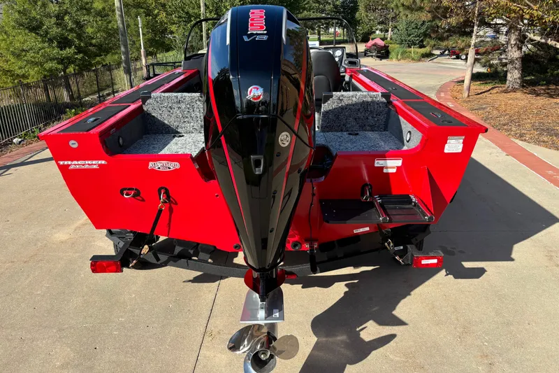 Slide: The Image of 2026 Tracker Targa V-19 Combo boat with powerful outboard motor, parked outdoors. - 2