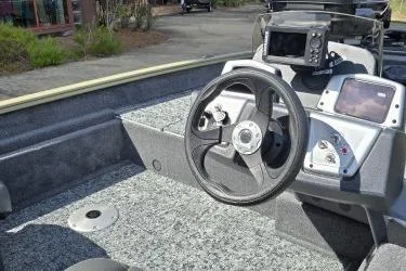 Slide: The Image of 2026 Tracker Pro Team 175 Crappie Edition boat interior with steering wheel and control panel. - 3