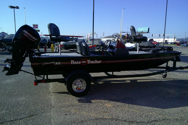 Slide: The Image of 2026 Tracker Bass Tracker Classic XL fishing boat with Mercury outboard motor in parking lot. - 3