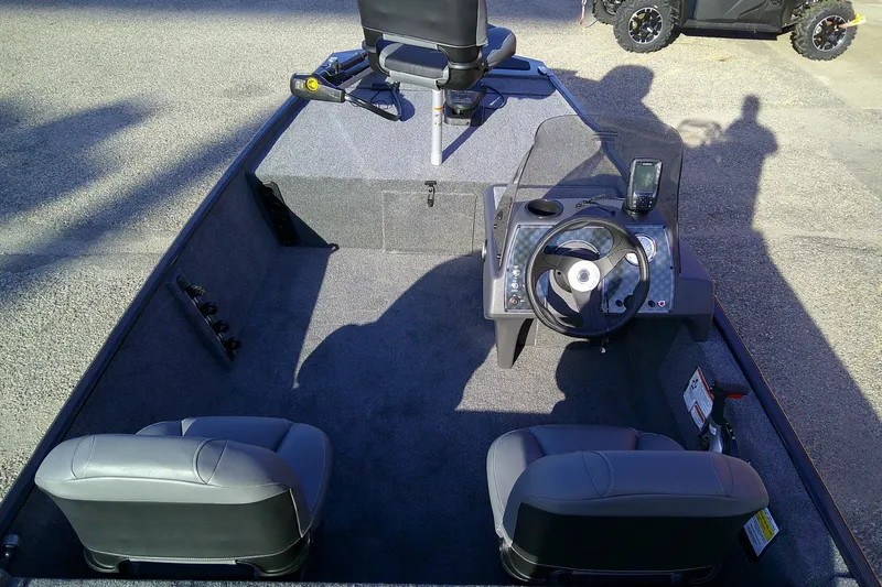 Slide: The Image of 2026 Tracker Bass Tracker Classic XL boat interior with steering console and seating. - 6