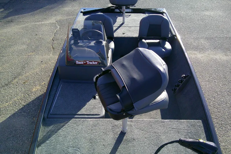 Slide: The Image of 2026 Tracker Bass Tracker Classic XL boat interior with seating and steering console. - 8