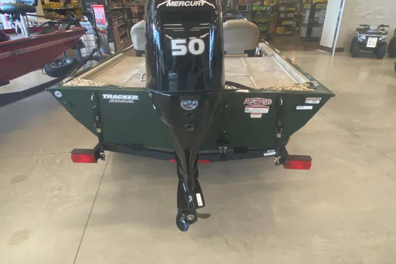 Slide: The Image of 2026 Tracker Bass Tracker Classic Limited boat with Mercury 50 outboard motor in showroom. - 2