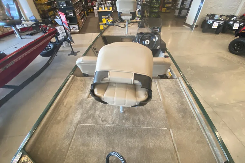 Slide: The Image of 2026 Tracker Bass Tracker Classic Limited boat interior with beige seating in showroom. - 3