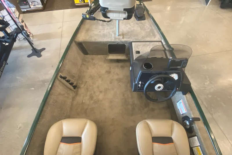 Slide: The Image of 2026 Tracker Bass Tracker Classic Limited boat interior with steering console and seating. - 4