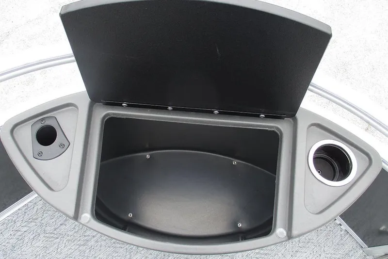 Slide: The Image of 2026 Sun Tracker Bass Buggy 18 DLX storage compartment with cup holders and open lid. - 13