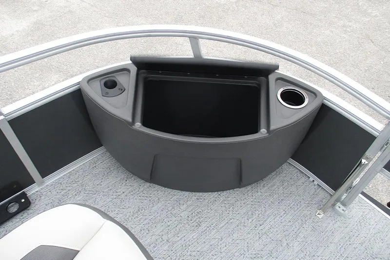 Slide: The Image of 2026 Sun Tracker Bass Buggy 18 DLX boat interior with storage compartment and cup holders. - 14