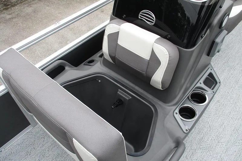Slide: The Image of 2026 Sun Tracker Bass Buggy 18 DLX boat interior with storage compartment and cup holders. - 19