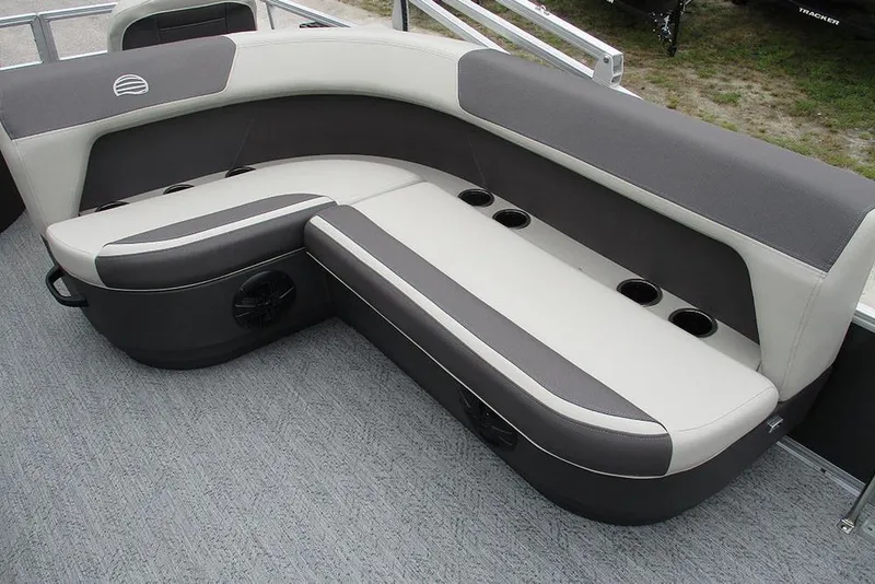 Slide: The Image of 2026 Sun Tracker Bass Buggy 18 DLX pontoon boat seating with cup holders and gray upholstery. - 21