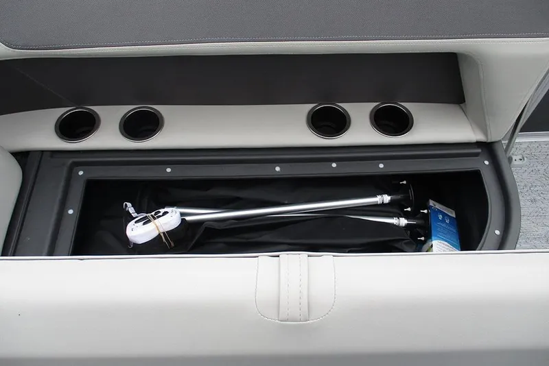 Slide: The Image of 2026 Sun Tracker Bass Buggy 18 DLX storage compartment with cup holders and accessories. - 23