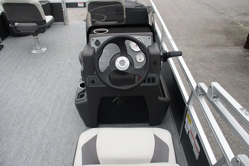 Slide: The Image of 2026 Sun Tracker Bass Buggy 18 DLX boat interior with steering console and seating. - 28