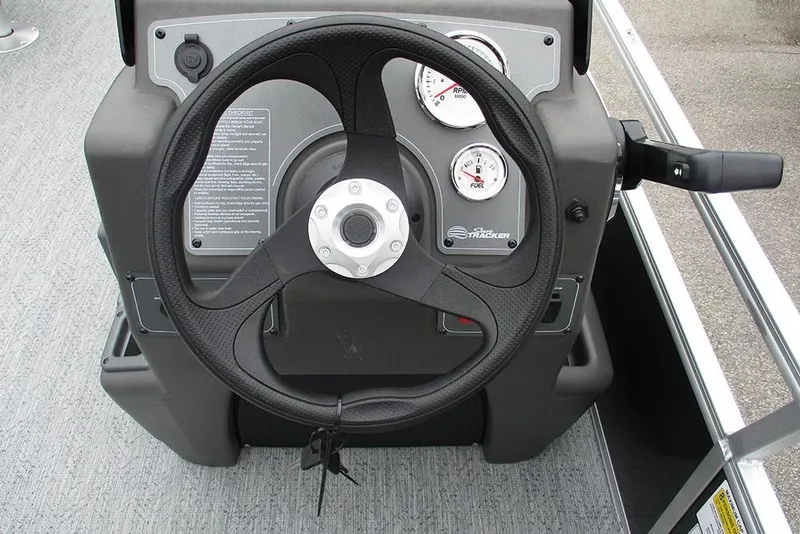 Slide: The Image of 2026 Sun Tracker Bass Buggy 18 DLX steering console with gauges and controls. - 29