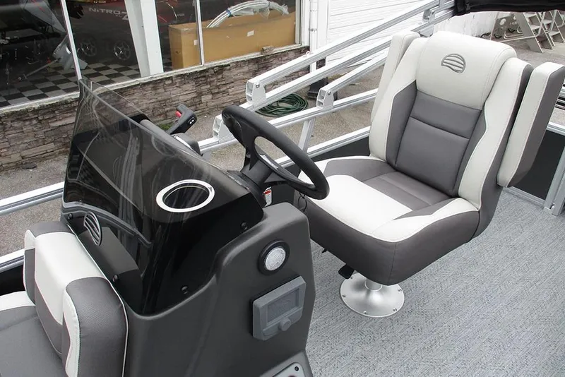 Slide: The Image of 2026 Sun Tracker Bass Buggy 18 DLX interior with steering console and captain's chair. - 30