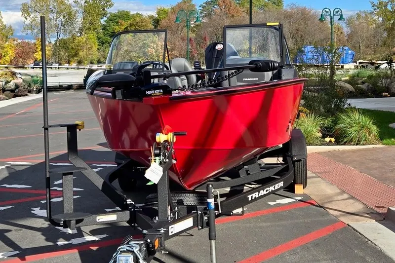Slide: The Image of 2026 Tracker Targa V-19 Combo boat on trailer, side view, beige color. - 2