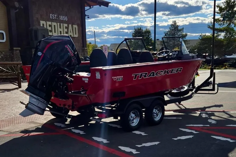 Slide: The Image of 2026 Tracker Targa V-19 Combo boat on trailer, parked outdoors. - 5