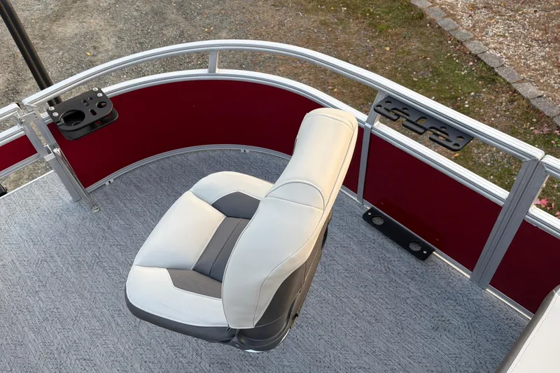 Slide: The Image of 2026 Sun Tracker Bass Buggy 16 XL Select boat seat with red paneling and fishing rod holders. - 70