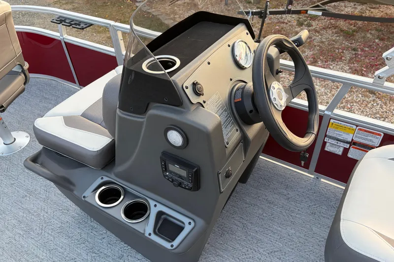 Slide: The Image of 2026 Sun Tracker Bass Buggy 16 XL Select boat console with steering wheel and seating. - 78