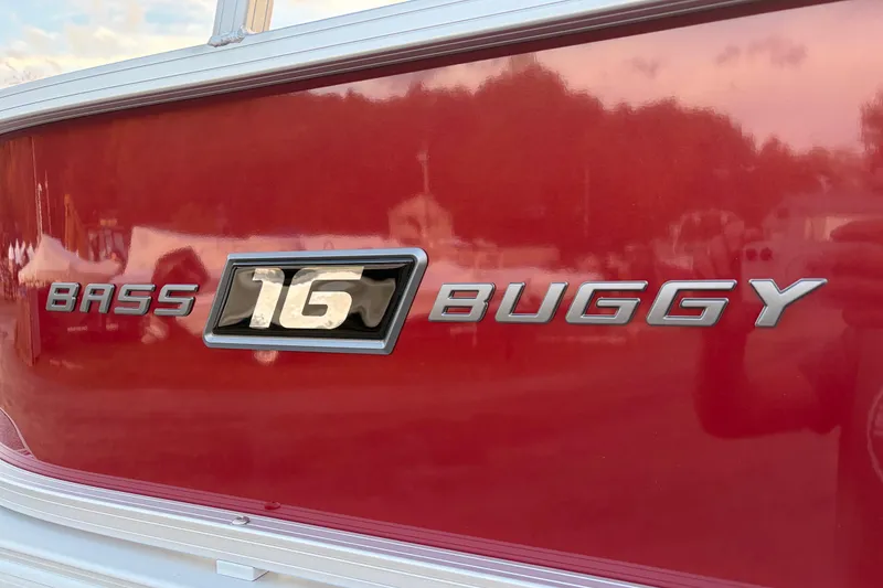 Slide: The Image of 2026 Sun Tracker Bass Buggy 16 XL Select, red exterior with chrome lettering. - 84