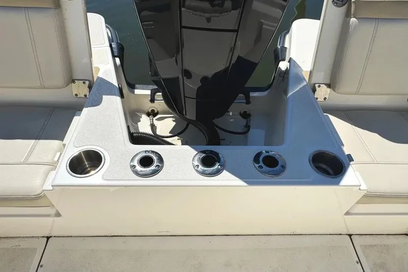 Slide: The Image of Boston Whaler 220 Dauntless 2022 boat interior with cup holders and seating. - 16