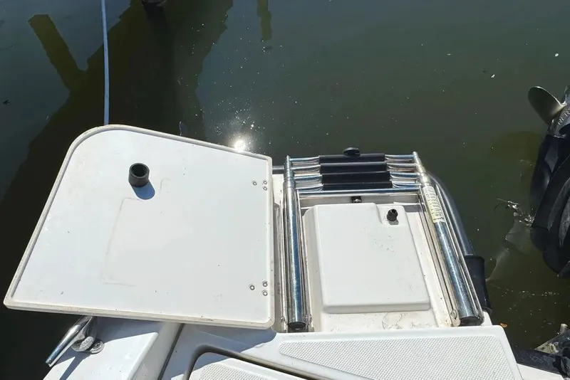 Slide: The Image of Boston Whaler 220 Dauntless 2022 boat with swim platform and ladder in water. - 17
