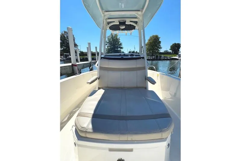 Slide: The Image of 2022 Boston Whaler 220 Dauntless boat interior with cushioned seating and canopy. - 23