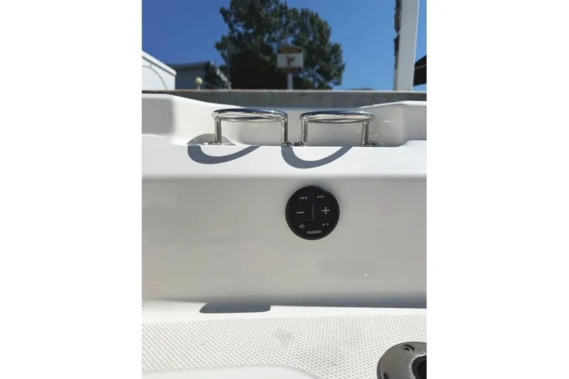 Slide: The Image of 2022 Boston Whaler 220 Dauntless boat console with audio controls and cup holders. - 26