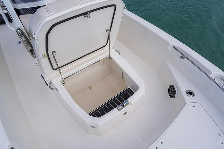 Slide: The Image of Manufacturer Provided Image: 2022 Boston Whaler 220 Dauntless boat storage compartment open, showing spacious interior. - 29