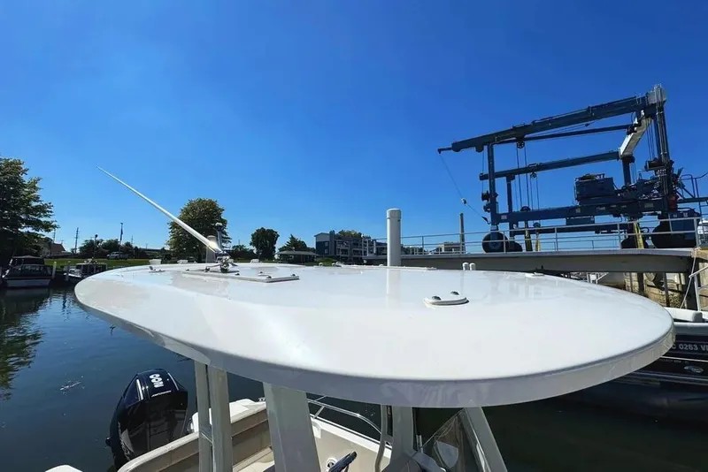 Slide: The Image of 2022 Boston Whaler 220 Dauntless boat docked under clear blue sky. - 31