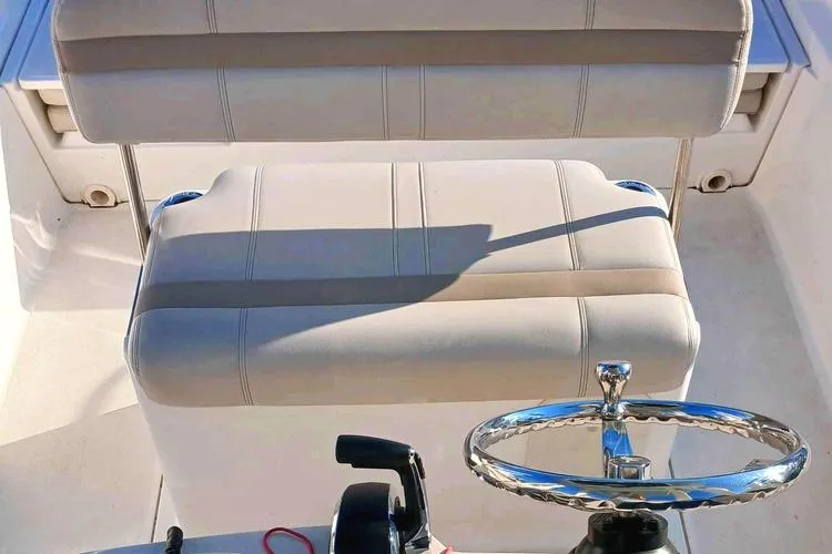 Slide: The Image of Boston Whaler 220 Dauntless 2022 boat interior with steering wheel and seating. - 7
