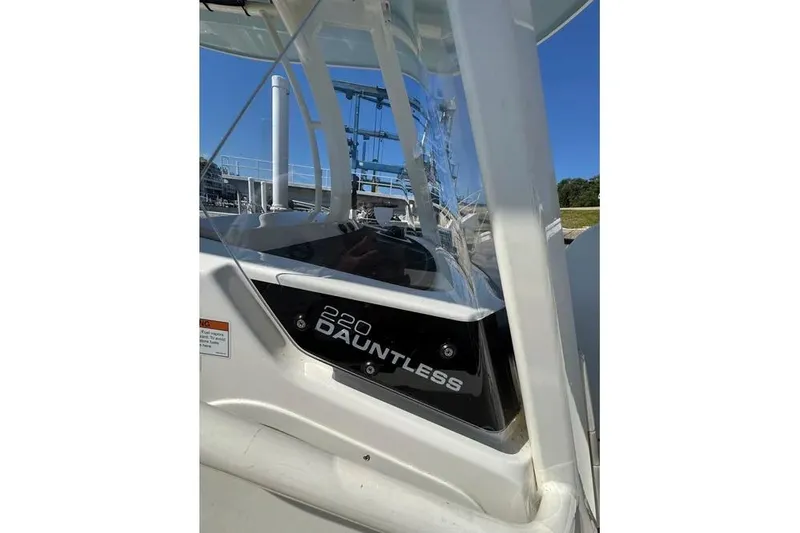 Slide: The Image of 2022 Boston Whaler 220 Dauntless boat, close-up view of the side panel. - 8