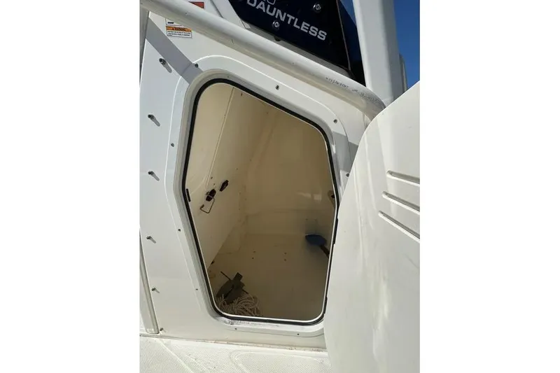 Slide: The Image of 2022 Boston Whaler 220 Dauntless boat storage compartment with open hatch. - 9