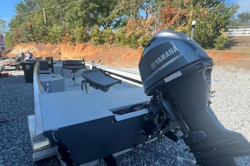 Slide: The Image of Custom 1660 PF boat with Yamaha outboard motor, parked on gravel, 2026 model. - 4