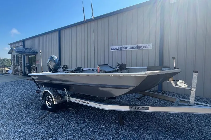 Slide: The Image of Custom 1660 PF boat on trailer outside Andalusia Marine, 2026 model. - 9