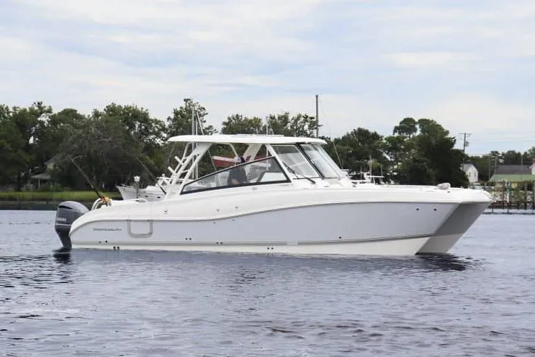 The Image of 2026 World Cat 325 DC cruising on open water with passengers onboard. - 0