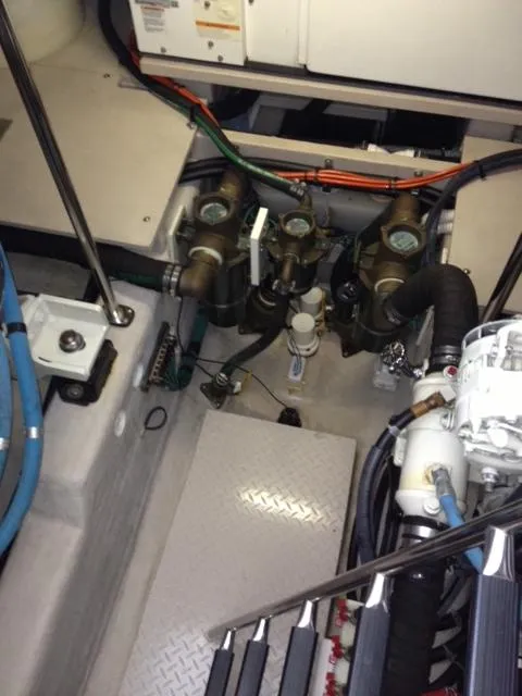 Slide: The Image of Engine compartment of a 2004 Sea Ray 500 Sundancer with visible hoses and machinery. - 11