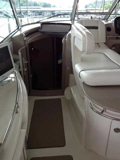 Slide: The Image of 2004 Sea Ray 500 Sundancer interior with white seating and helm station. - 15