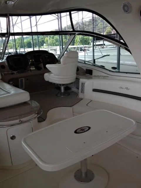 Slide: The Image of 2004 Sea Ray 500 Sundancer yacht interior with helm, seating, and table. - 18