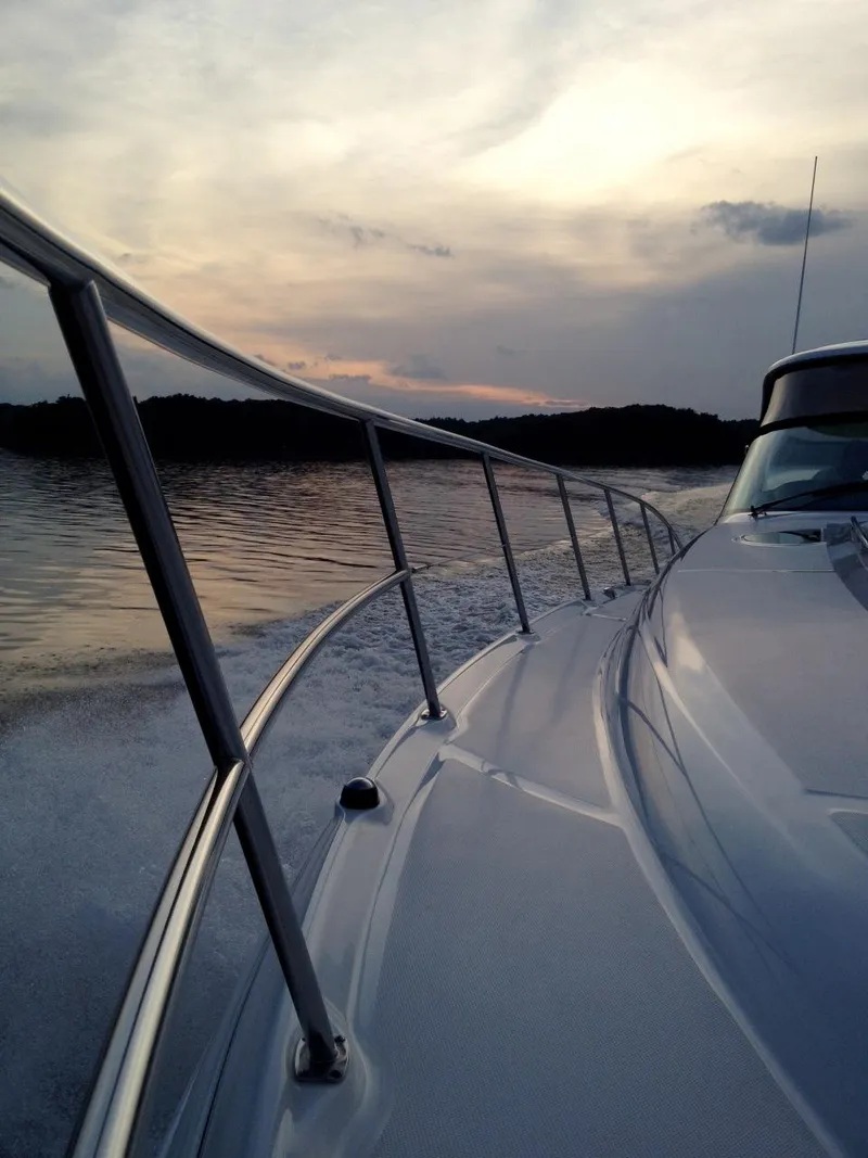 Slide: The Image of 2004 Sea Ray 500 Sundancer cruising at sunset on calm waters. - 20