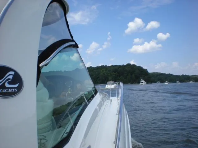 Slide: The Image of 2004 Sea Ray 500 Sundancer cruising on a sunny day with blue skies and distant boats. - 24