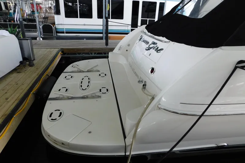 Slide: The Image of 2004 Sea Ray 500 Sundancer yacht docked, showcasing rear deck and sleek design. - 27