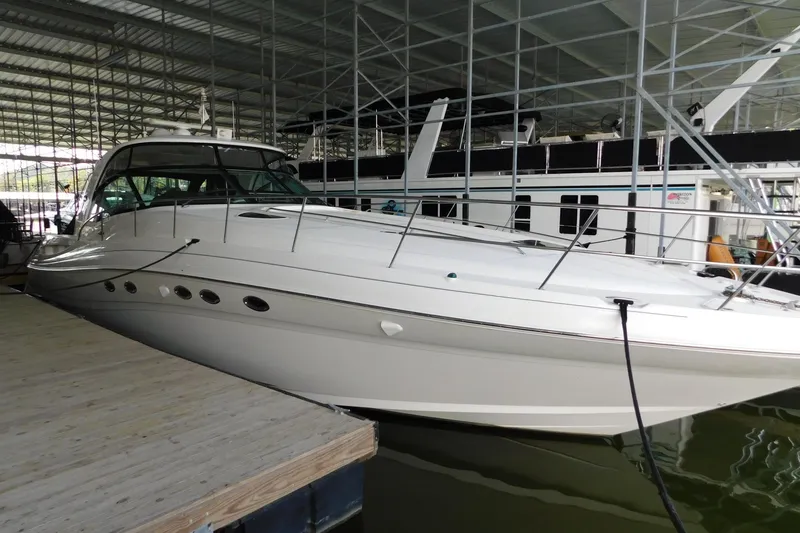 Slide: The Image of 2004 Sea Ray 500 Sundancer yacht docked in a covered marina. - 3