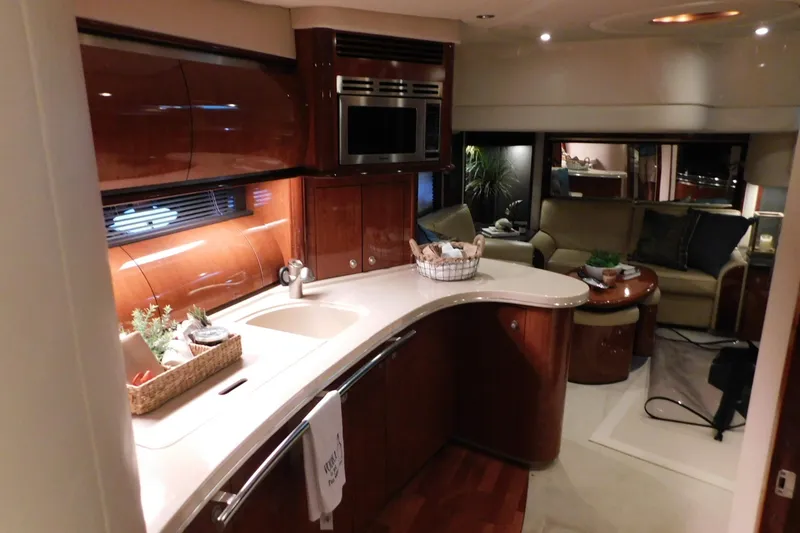 Slide: The Image of Luxurious interior of a 2004 Sea Ray 500 Sundancer yacht with modern kitchen and cozy seating area. - 33