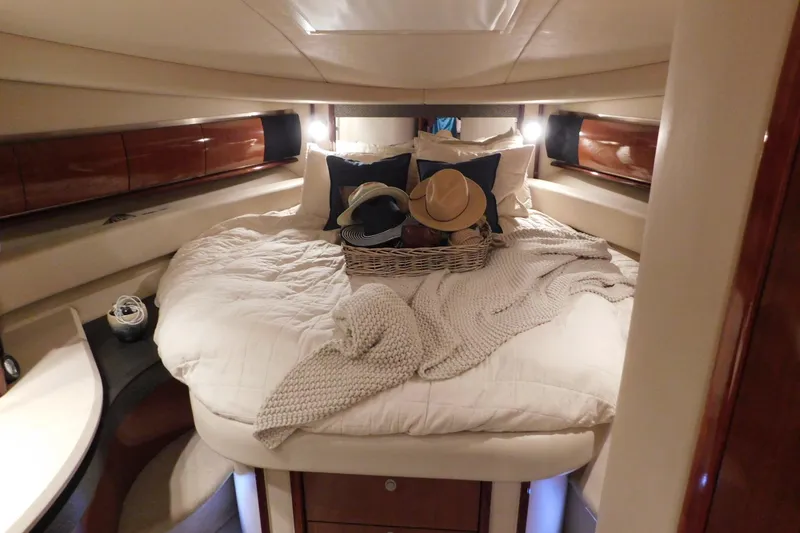 Slide: The Image of Luxurious 2004 Sea Ray 500 Sundancer cabin with cozy bed and stylish decor. - 34