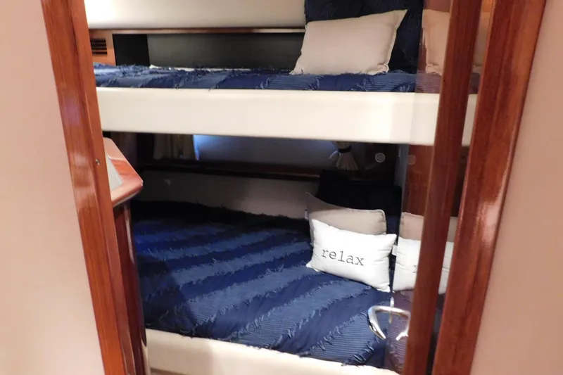 Slide: The Image of Interior of 2004 Sea Ray 500 Sundancer with cozy bunk beds and "relax" pillow. - 37