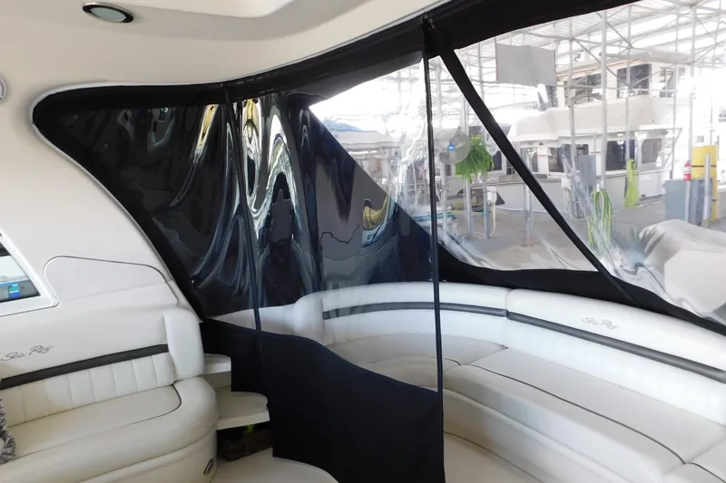Slide: The Image of Interior of 2004 Sea Ray 500 Sundancer yacht with white seating and clear enclosure. - 40