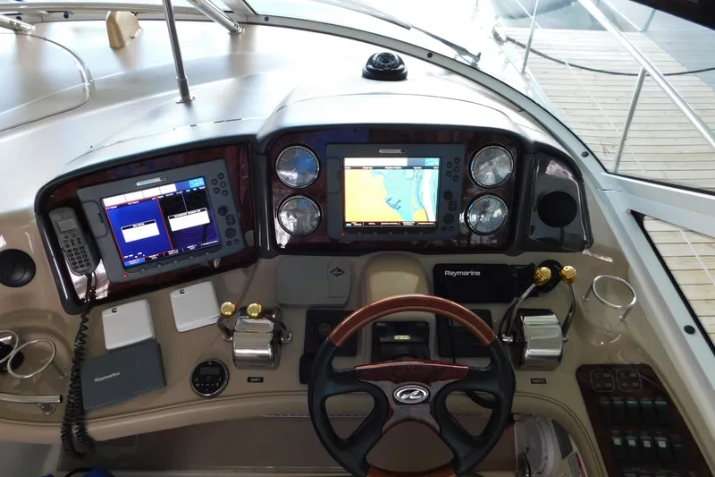 Slide: The Image of Cockpit of 2004 Sea Ray 500 Sundancer with navigation screens and controls. - 42