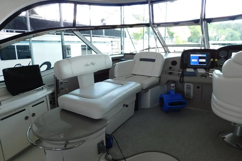 Slide: The Image of Interior of 2004 Sea Ray 500 Sundancer yacht with white seating and navigation equipment. - 47