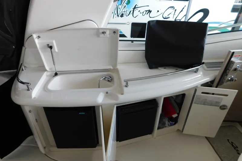 Slide: The Image of 2004 Sea Ray 500 Sundancer yacht interior with sink, storage, and mini fridge. - 48